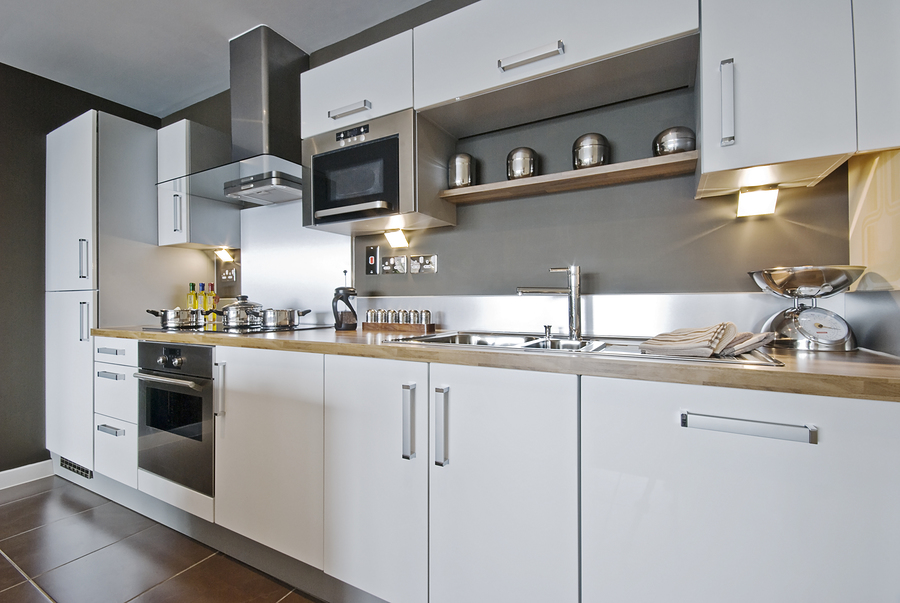 A modern galley kitchen with a lot of storage and natural light.