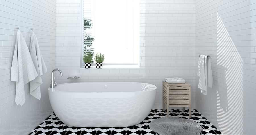 Modern bathroom renovation full of natural light from large window.