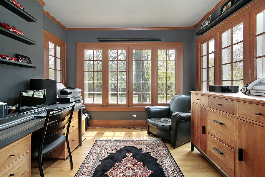 Home office with wall of windows around room