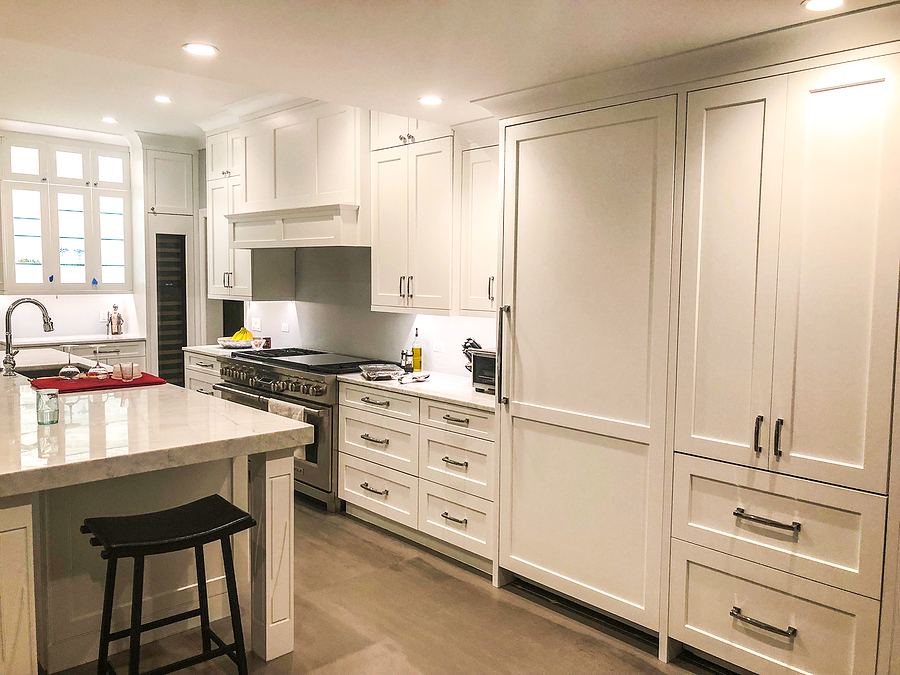 Newly renovated kitchen with white cabinets and a large island.