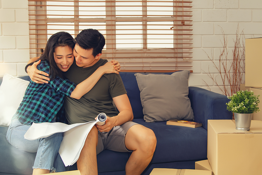 Happy young couple looking at home renovation plans.