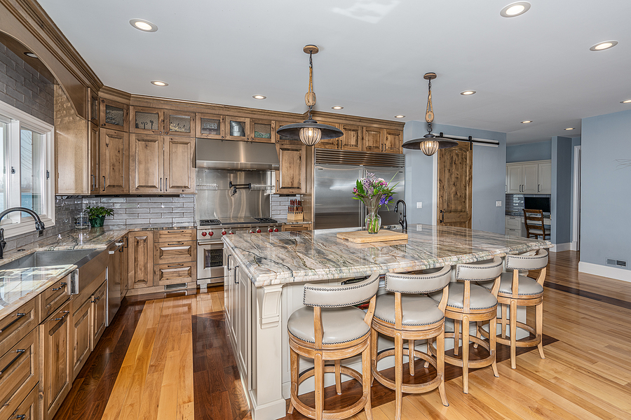 Updated kitchen with lots of new cabinets and a large island full of storage space/. Granit countertops with wood finished cabinets.